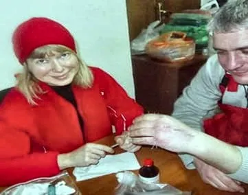 Лідія Буцька ставить голки на кисті пацієнта